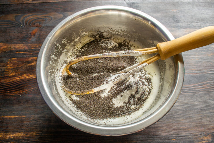 Pouring dry poppy seeds Pouring dry poppy seeds into the cake batter