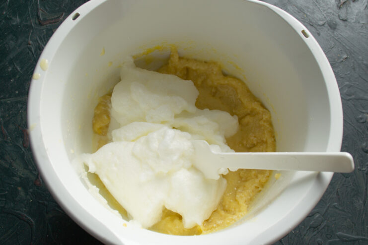 Folding In Egg Whites Folding fluffy whipped egg whites into thick cake batter