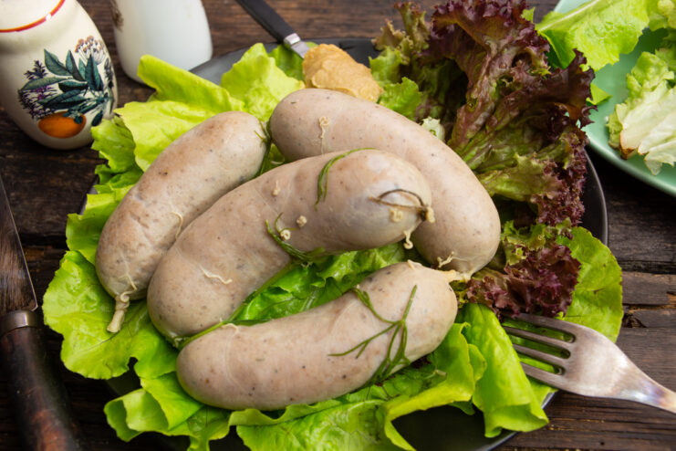 Homemade pork sausages with mustard on a plate