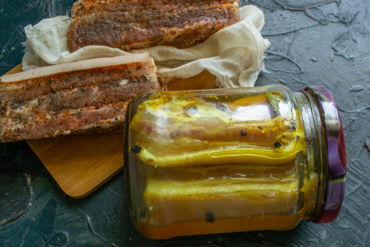 Comparing the Two Curing Methods Two types of cured pork belly side by side: one in paprika and one in turmeric brine