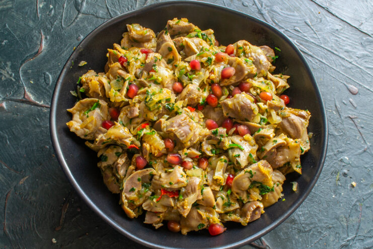 Finished Georgian-style chicken gizzards Final serving of chicken gizzard kuchmachi on a plate