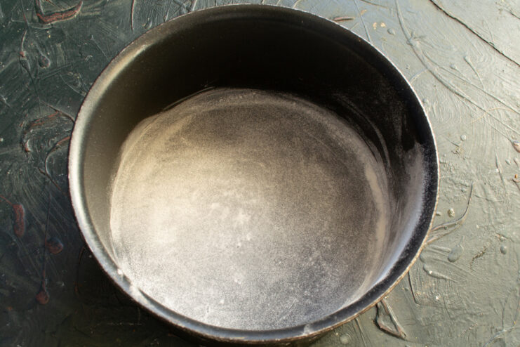 Preparing The Cake Pan Round cake pan greased with butter and dusted with flour