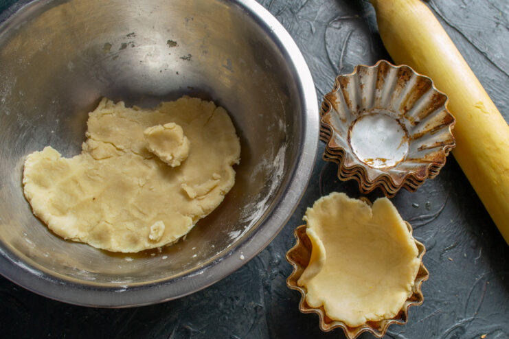 Preparing Tartlet Shells Pressing shortcrust dough into classic metal molds