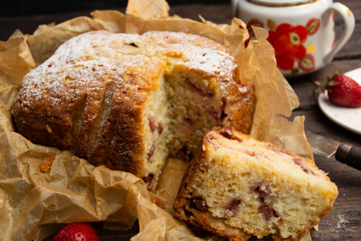 Sliced orange and strawberry fruit cake on a plate