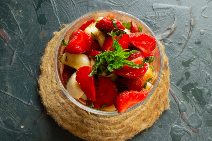 Plating The Fruit Salad Finished strawberry fruit salad served in bowls