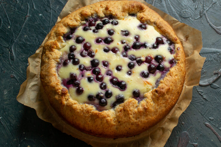 Baked galette resting on parchment paper outside the baking pan