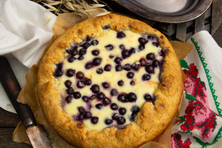 Baked tvorog and blackcurrant galette ready to be served on a table
