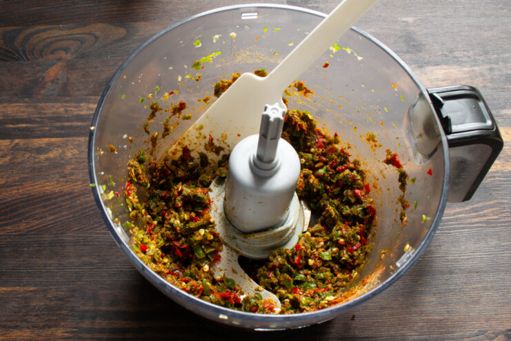 Ready adjika mixture Thick adjika with spices in a food processor bowl after final blending.
