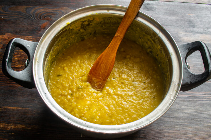 Thick cooked pearl barley and lentil porridge simmering in a pot