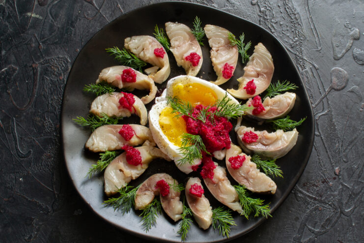 Final Mackerel Appetizer Presentation Finished mackerel slices topped with beet horseradish and fresh dill