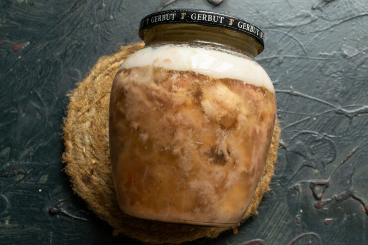 After slow cooking Finished sealed jar of cooked pork tushenka cooling down