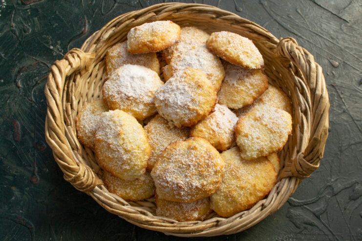 Serving the cookies Baked coconut cookies dusted with powdered sugar in a basket