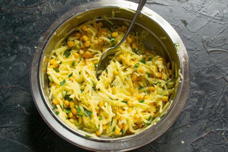 Finished fritter batter Thick mixed vegetable batter for fritters in a metal bowl
