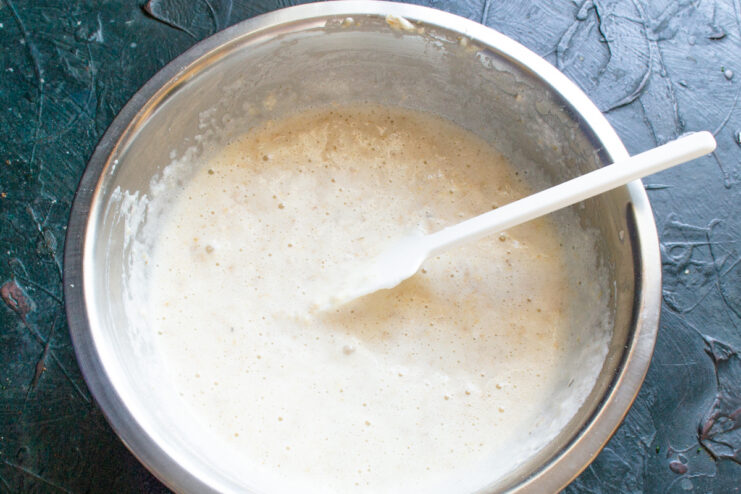 Final mixing of the batter Spatula folding whipped egg whites into the oat batter in a bowl