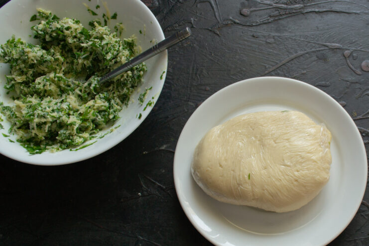 Preparing to Assemble Prepared dough and a bowl of filling on the workspace