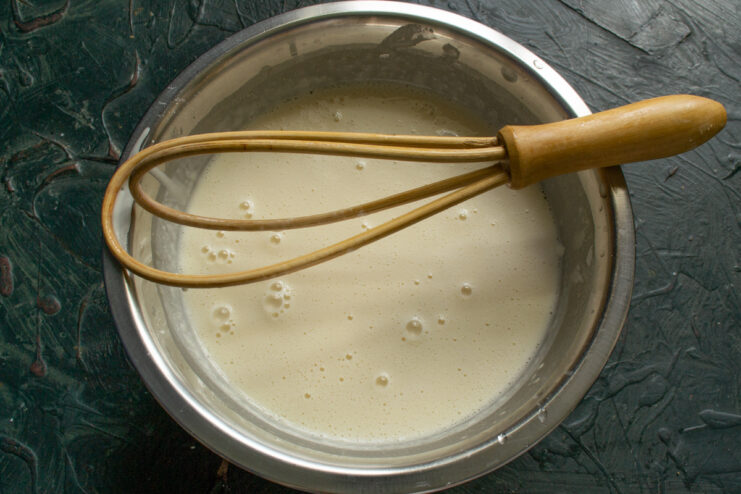 Letting the crepe batter rest Smooth liquid crepe batter resting in a mixing bowl