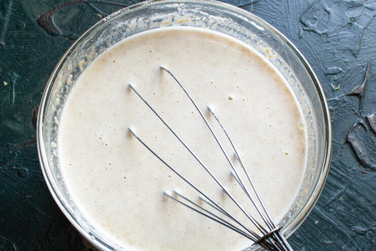 Resting the batter before frying Finished liquid crepe batter resting in a bowl