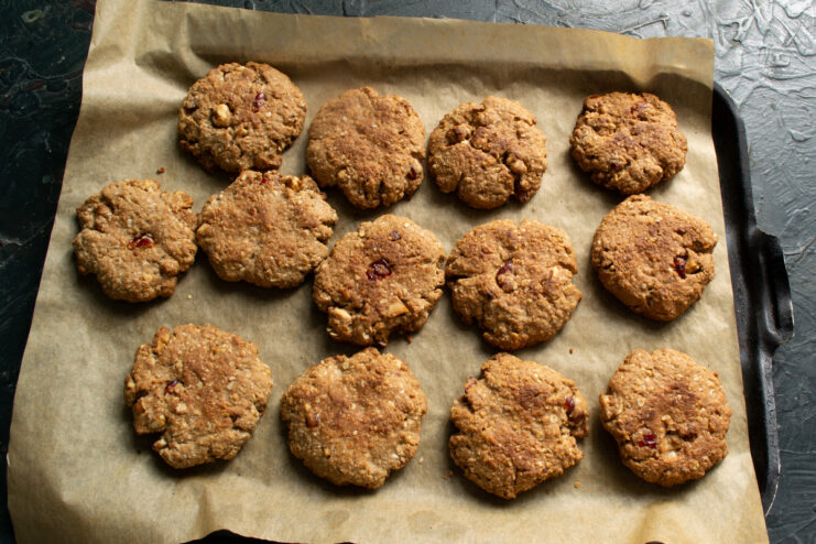 Baking process Freshly baked golden brown oatmeal cookies on a baking sheet