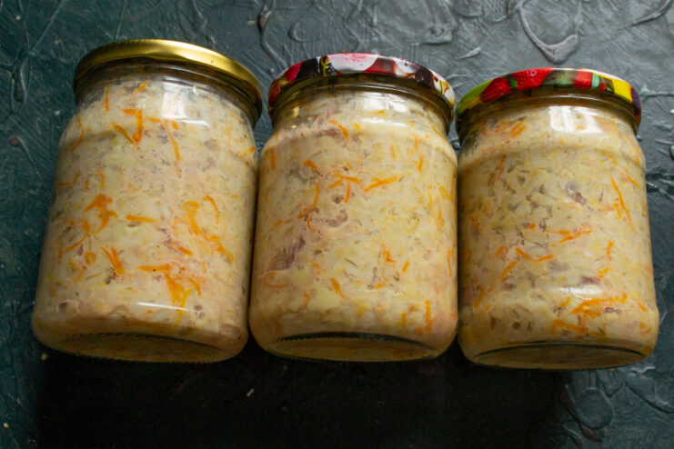 Finished canned stew Finished jars of pork stew with pearl barley sitting on a table