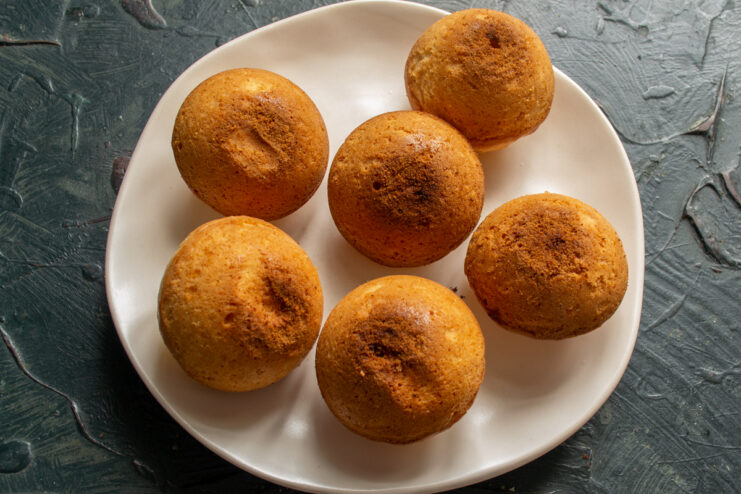 Cooling the Baked Buns Unmolded baked buns resting on a plate to cool down