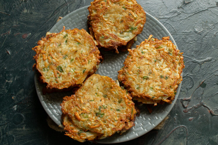 Fried golden fritters Cooked golden-brown sunchoke fritters resting on a plate