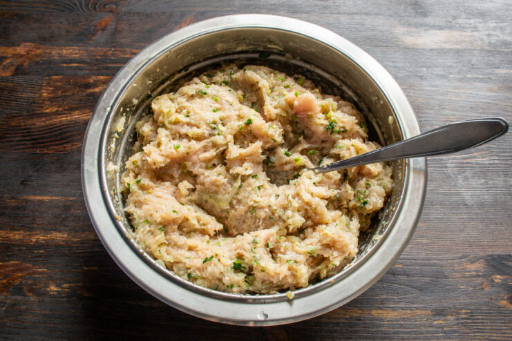 Resting the mixture Prepared chicken and cilantro patty mixture in a deep bowl