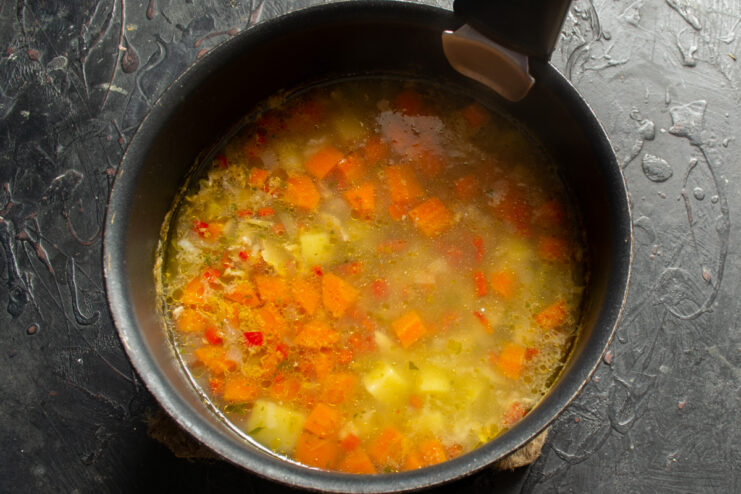 Final stage of cooking the soup Finished chicken and rice soup resting in a cooking pot