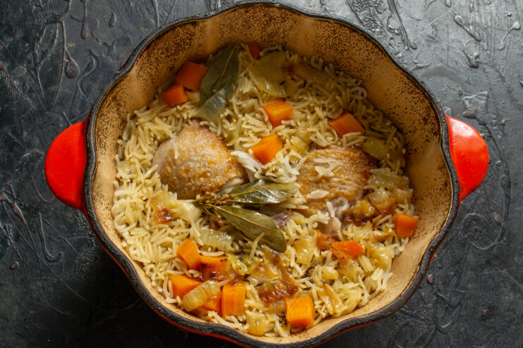 Plov resting after cooking Finished chicken plov resting in a covered Dutch oven