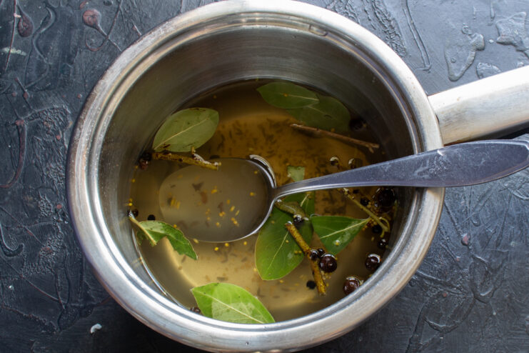 Dissolving salt and sugar in the brine Prepared spice brine resting in a saucepan