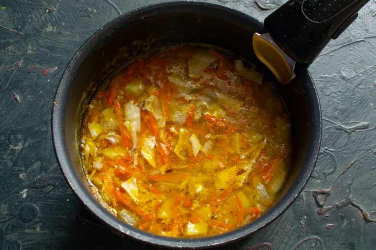 Finished soup in the pot Finished quick soup with canned meat and vegetables resting in the cooking pot.