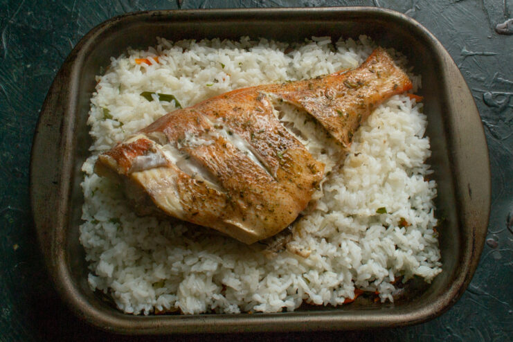 Resting the Baked Fish Freshly baked sea bass resting in a foil-covered baking dish