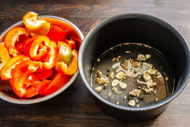 Preparing the spiced marinade Marinade ingredients with garlic and spices simmering in a saucepan