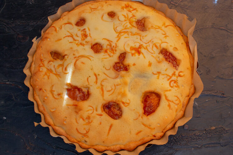 Cheesecake after baking Baked golden brown cheesecake in a springform pan
