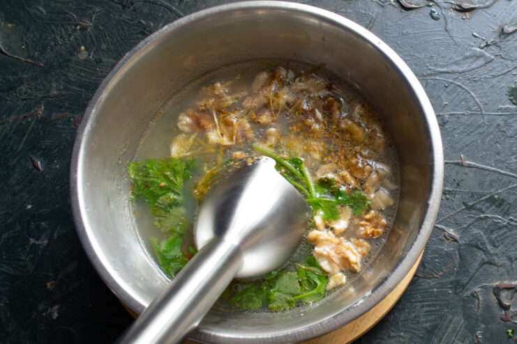 Blending the satsivi sauce Blending the satsivi sauce with an immersion blender until smooth
