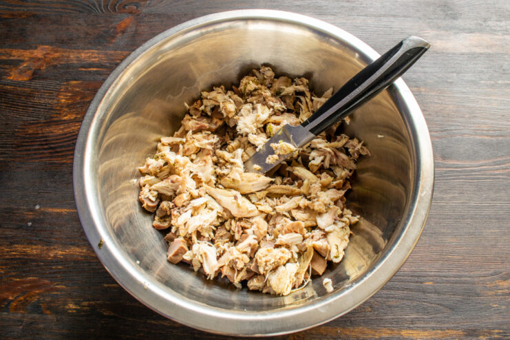 Shredding the Chicken Finely chopped cooked chicken meat added to diced gizzards