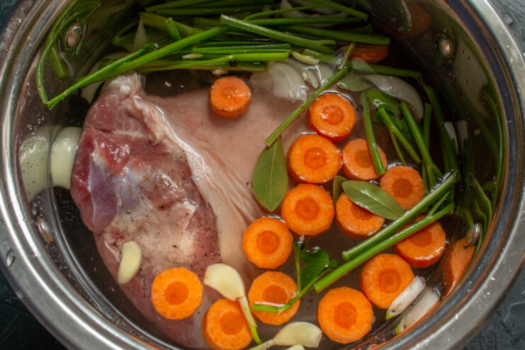 Ready for Boiling Pot filled with aspic ingredients covered in water.