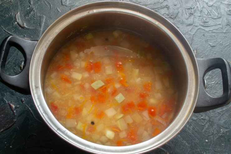 Cooking Soup Over Medium Heat Vegetable soup boiling in a stainless steel pot
