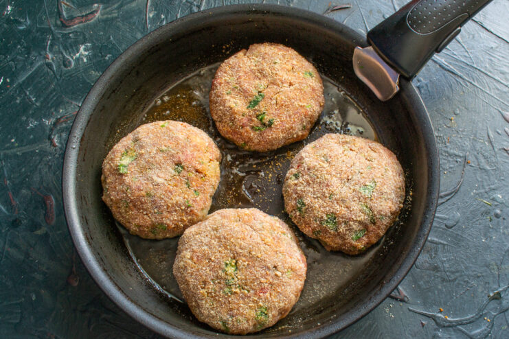 Pan-frying Meat patties frying in a skillet with hot vegetable oil