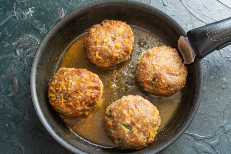 Simmering the patties Patties simmering in a small amount of broth in a covered skillet