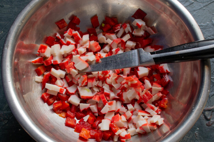 Adding Crab Sticks Diced crab sticks added to bell peppers