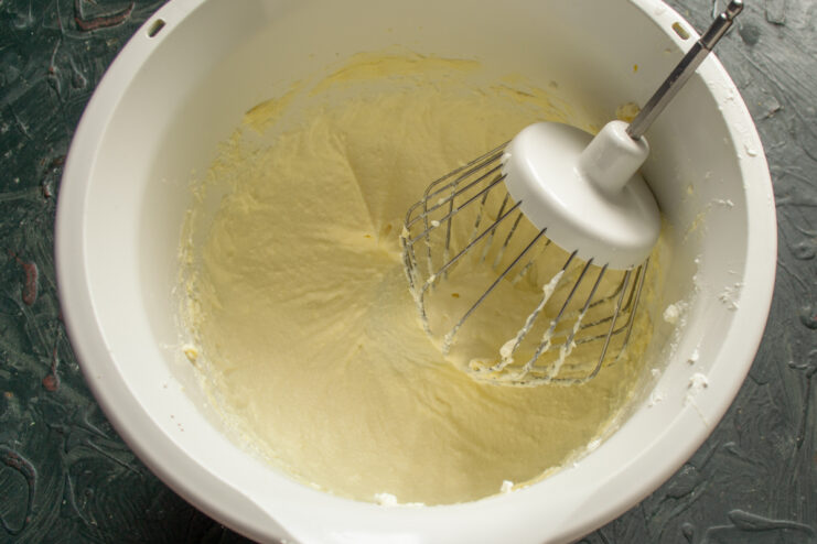 Preparing Mascarpone Frosting Whipped mascarpone and heavy cream frosting in a mixing bowl