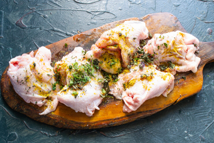 Boneless chicken thighs sprinkled with herbs and turmeric