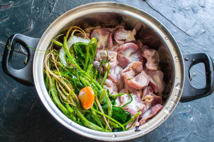 Ingredients for boiling the offal Chicken gizzards in a pot with root vegetables and spices