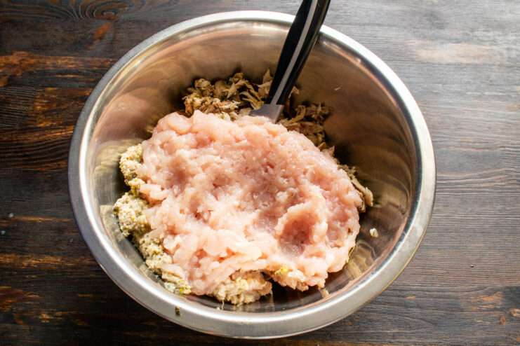 Grinding the Chicken Meat Minced chicken breast and skin in a mixing bowl