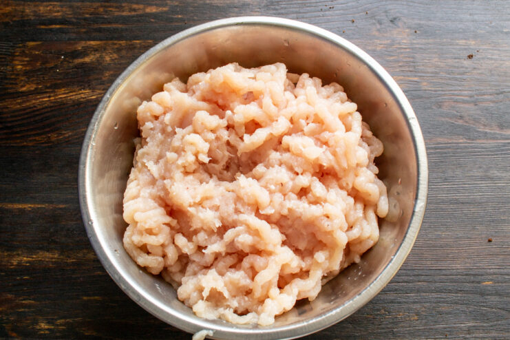 Grinding the chicken breast Ground chicken breast in a mixing bowl