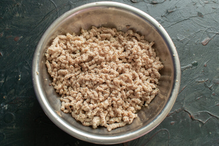 Ground Chicken Meat Freshly ground cooked chicken thigh meat in a bowl