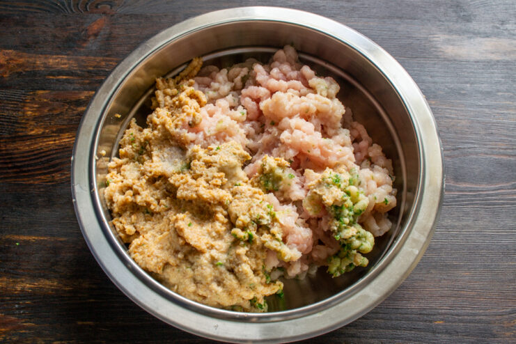 Mixing the meat Ground chicken mixed with bread and fresh cilantro