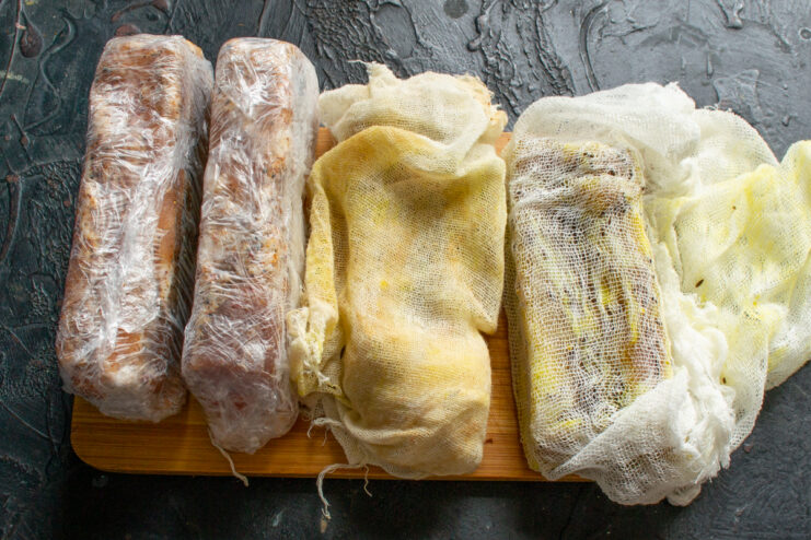 Storing the Homemade Cured Meat Pieces of cured pork belly wrapped in cheesecloth and plastic wrap ready for storage