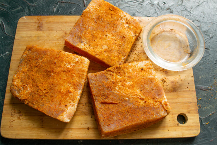 Coating in paprika Chunks of pork fat heavily coated in a vibrant red pepper and paprika blend