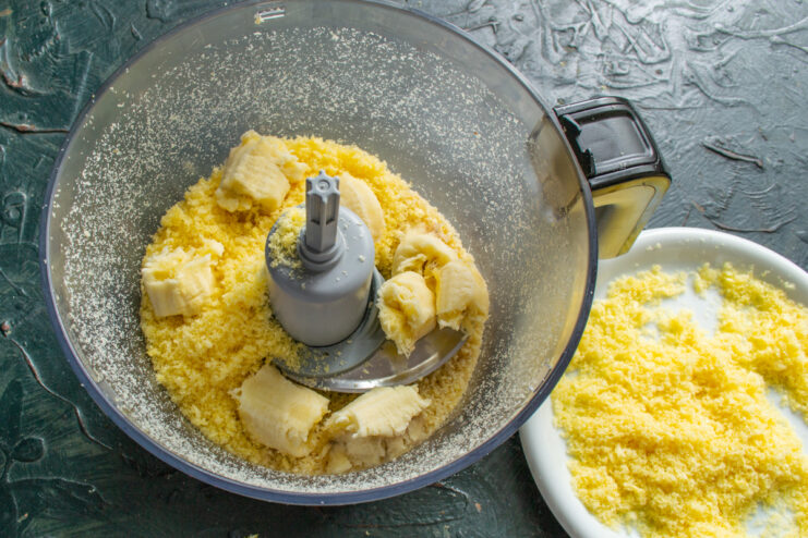 Chunks of ripe banana added to the crumb mixture in a blender